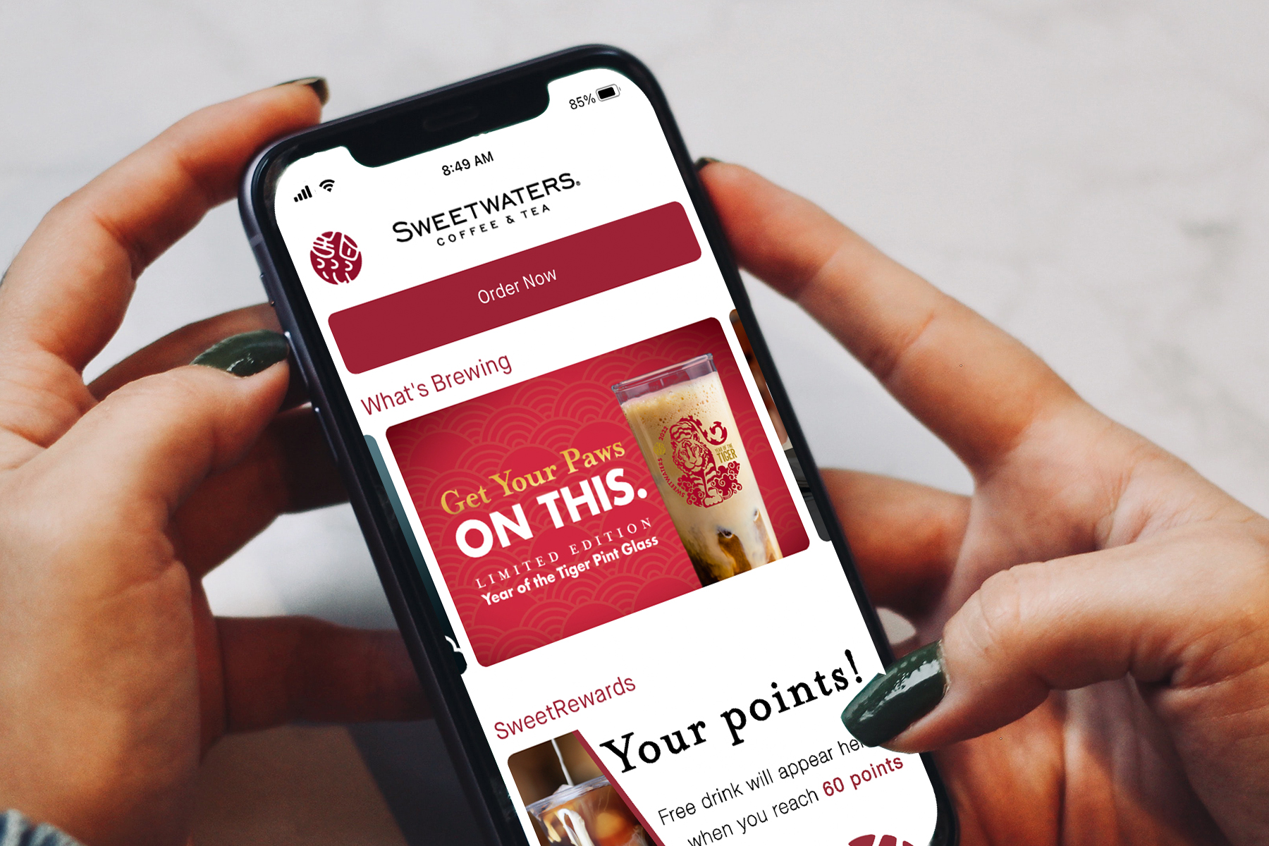 Sweetwaters Mobile app with an ad for the limited edition Eye of the Tiger Pint Glass and "Get your paws on this"