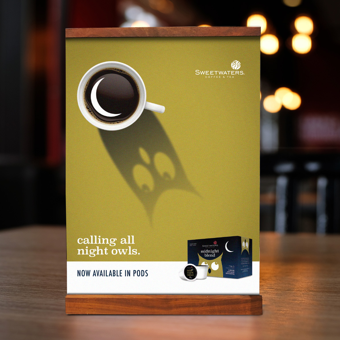 Tabletop ad featuring a coffee cup casting a shadow that looks like an owl, with the headline, “calling all night owls.”