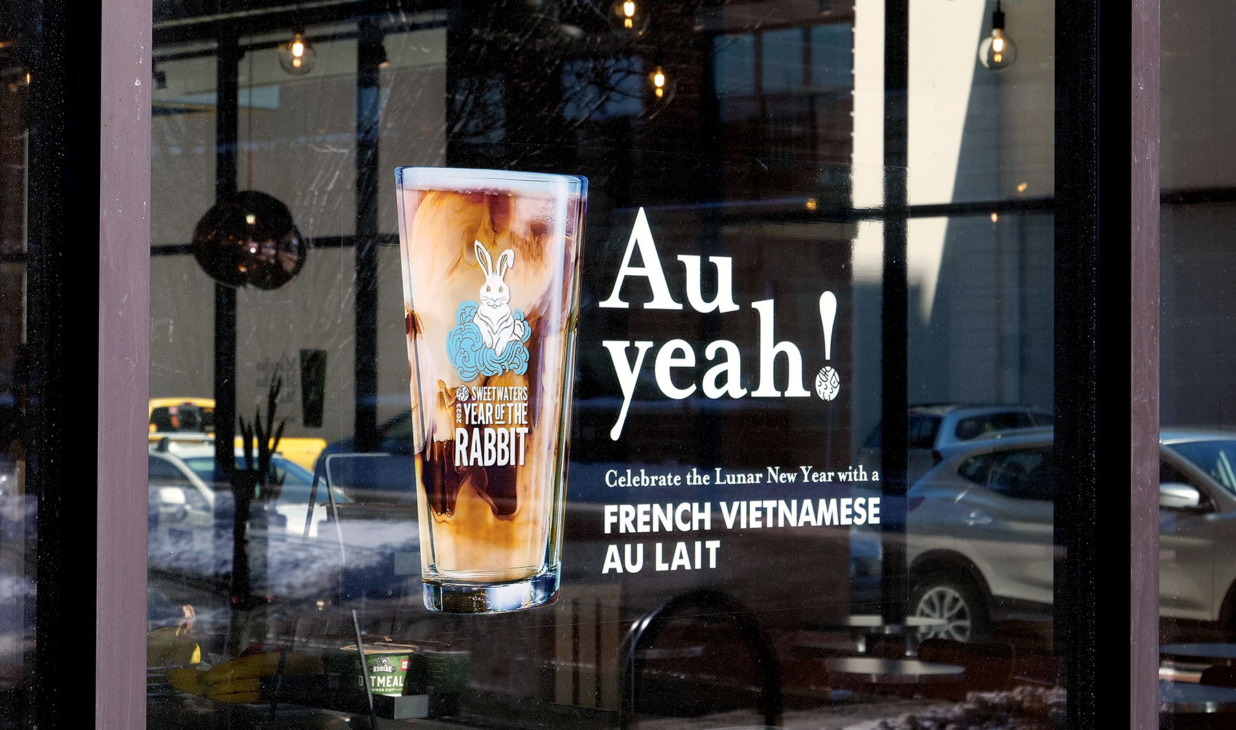 Window graphic of an iced latte with the Year of the Rabbit logo on the glass, with the headline, “Au yeah!”