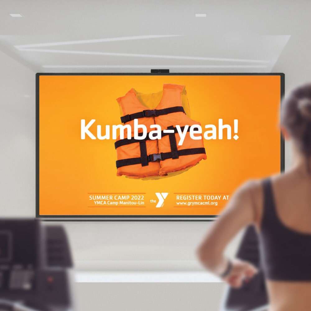 On premesis digital display featuring an orange image of a life jacket with the headline, “Kumba-yeah!” and details about summer camps.