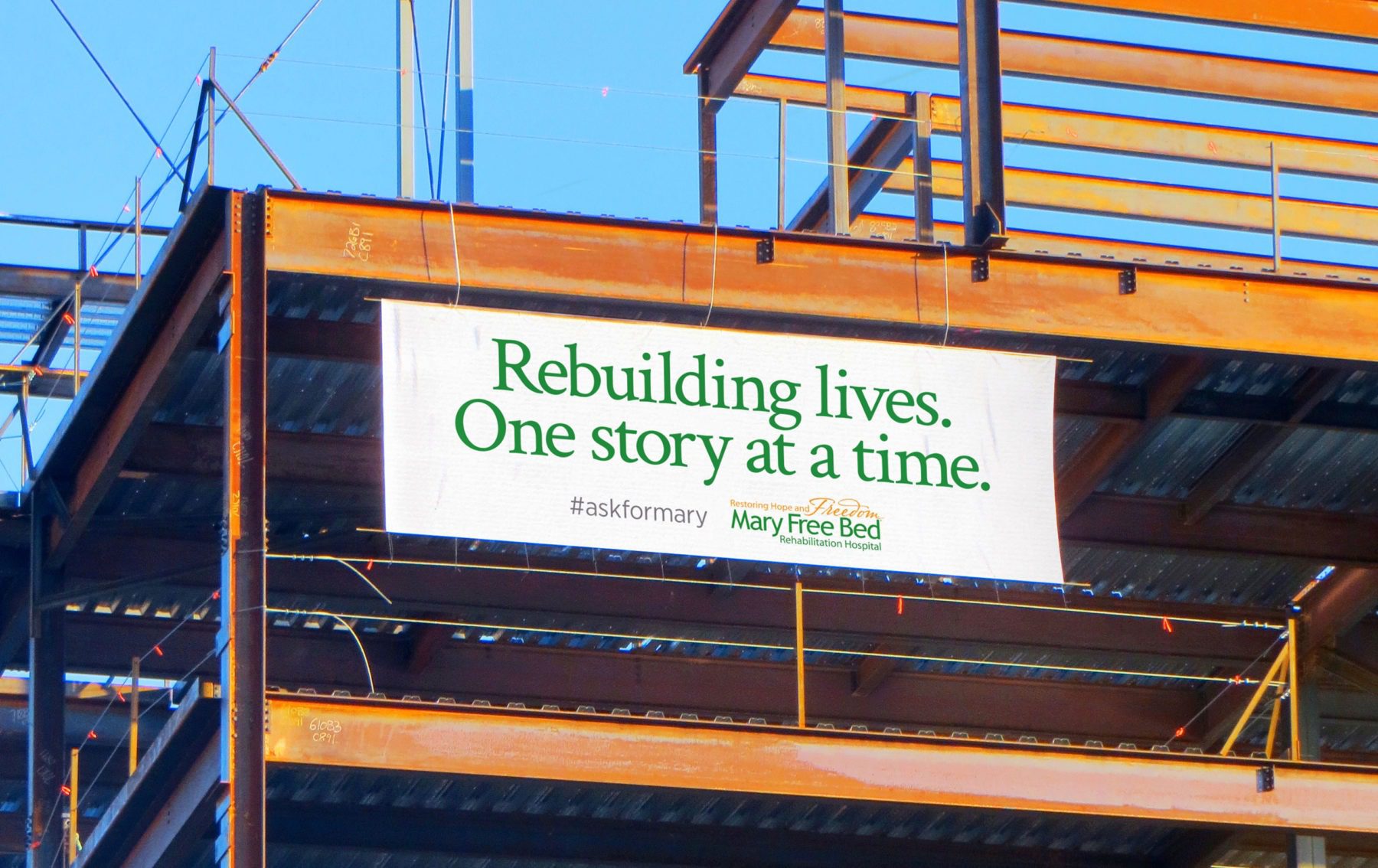 Construction banner with headline "Rebuilding lives. One story at a time."