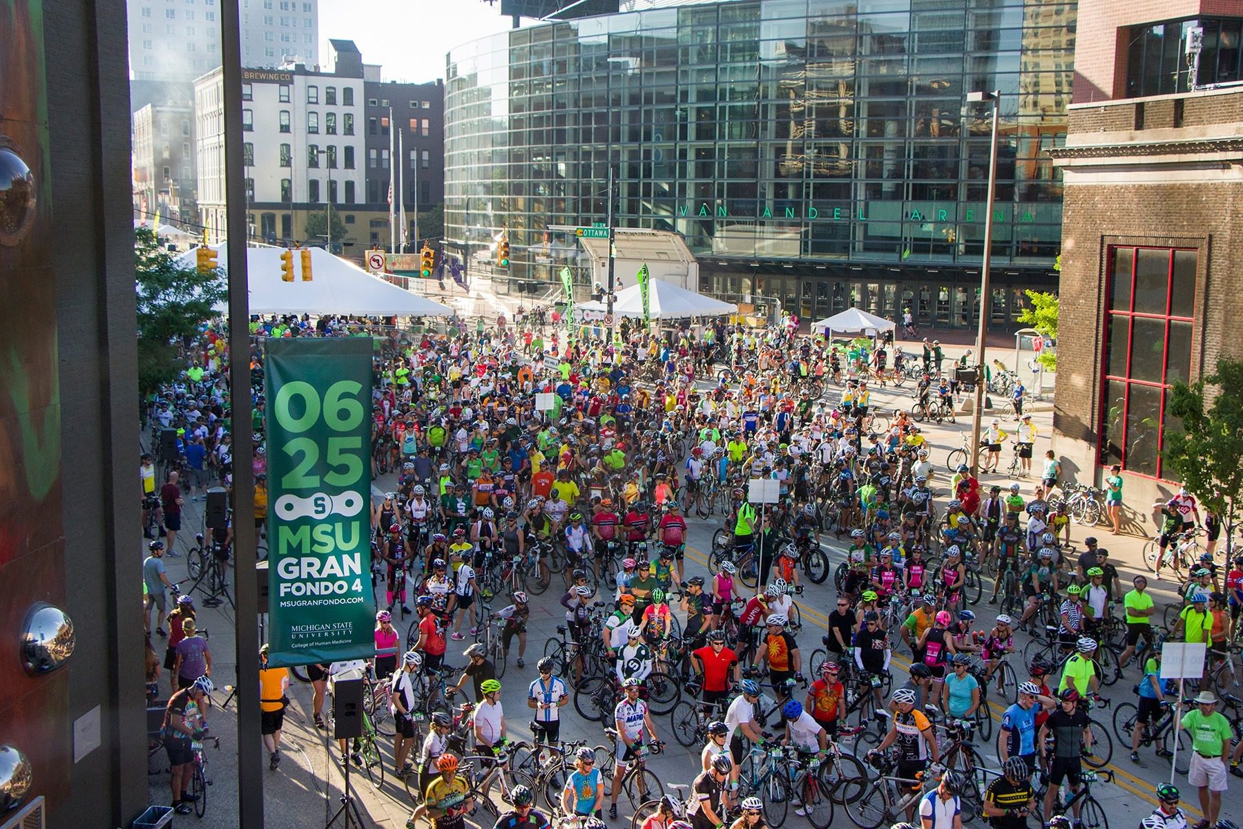 MSU Gran Fondo 4 event crowd photo showing street pole banner.