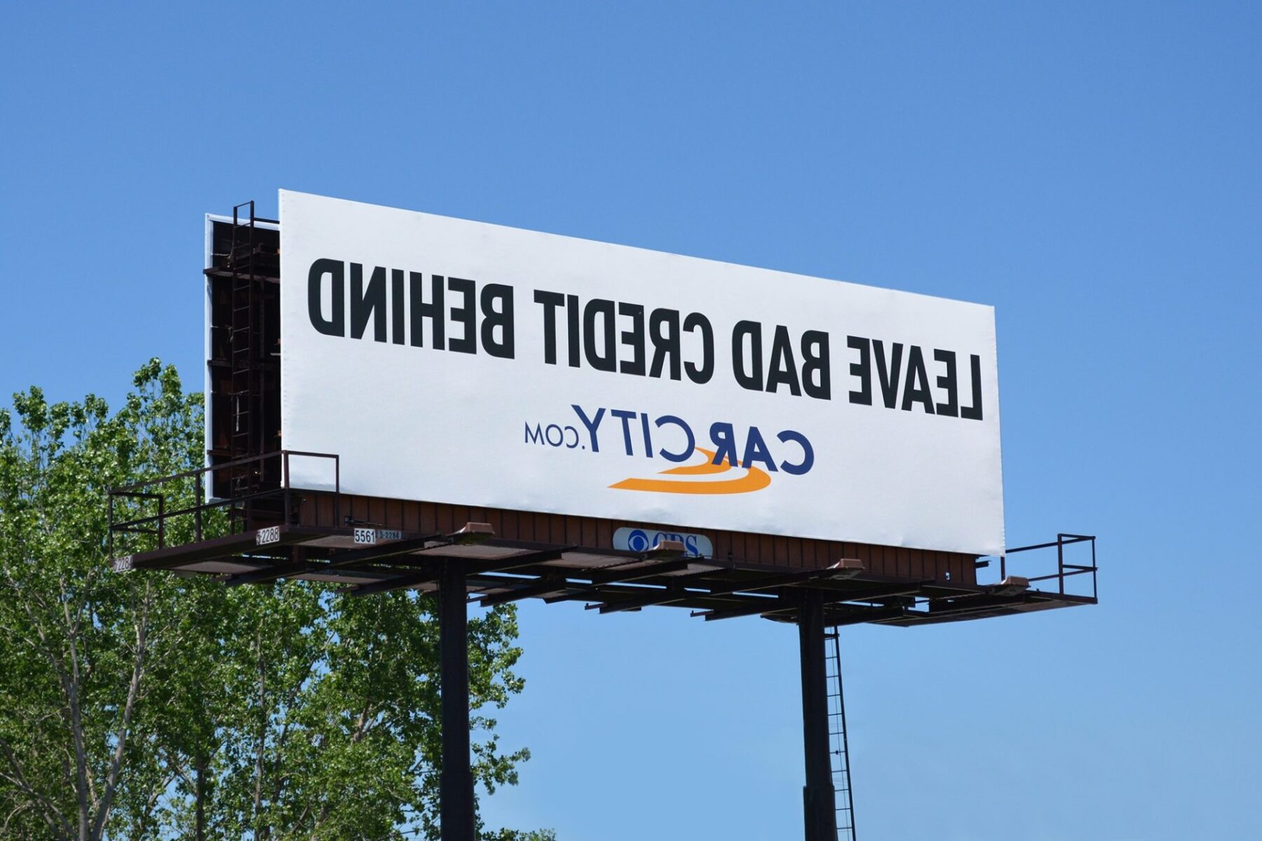 Leave Bad Credit Behind. Car City. Text backwards.