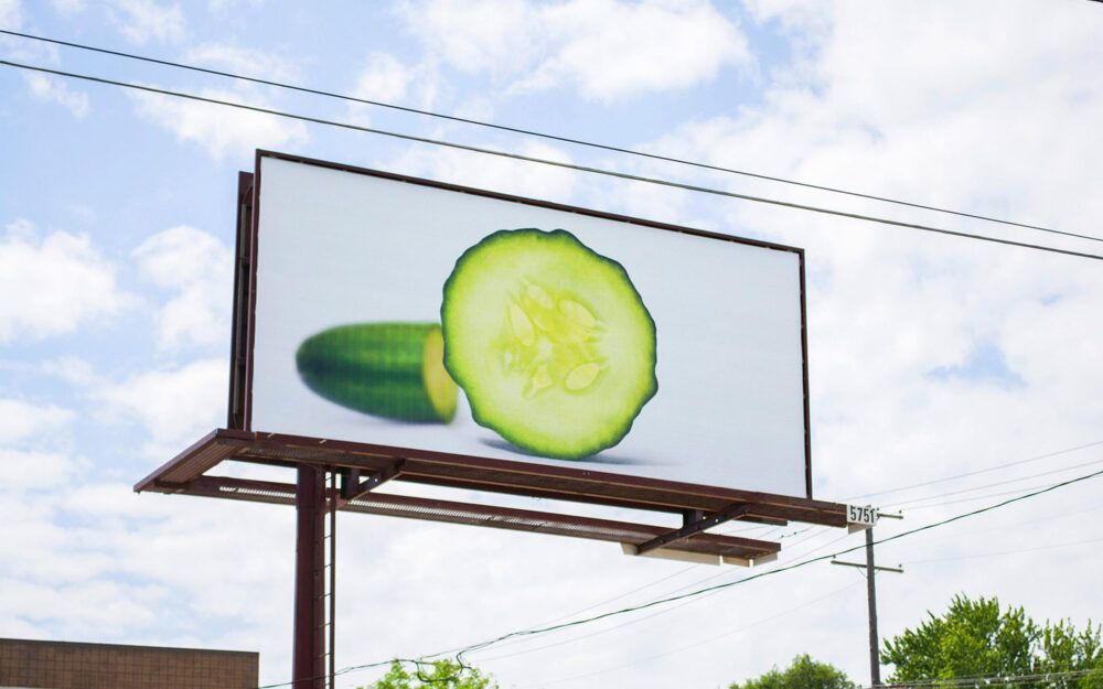 Billboard teaser for Gordon Food Service showing a cut cucumber on a white background