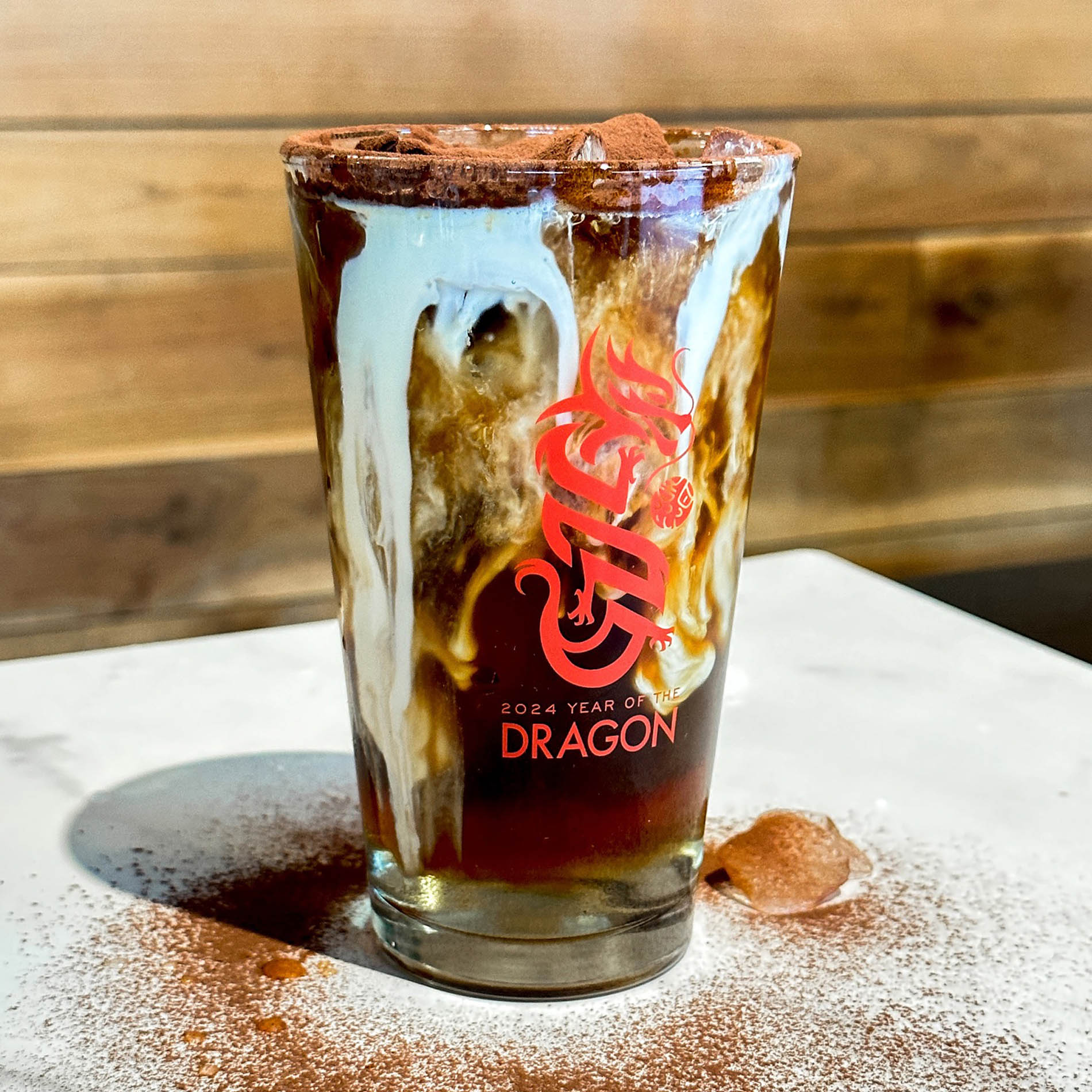 Custom glass designed for Sweetwaters featuring an illustration of the year of the dragon with the line, “2024 year of the dragon.”