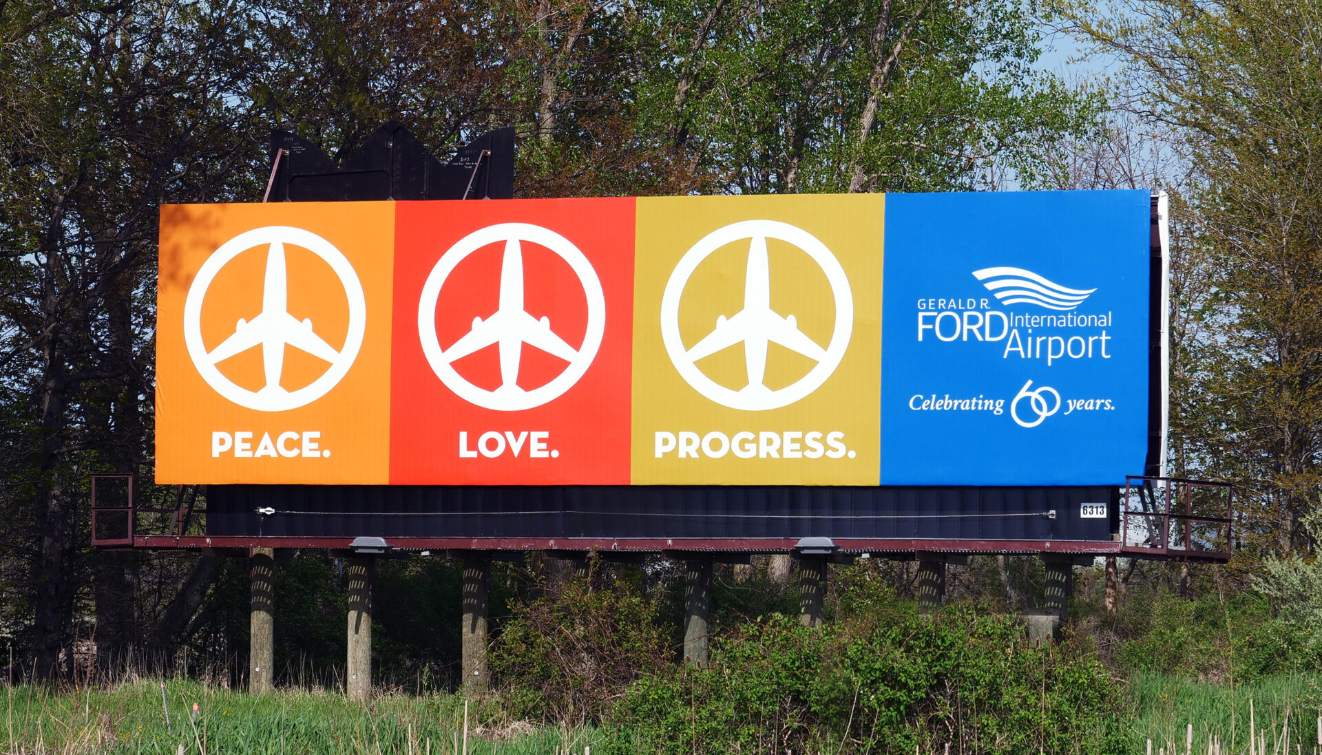 Out of home 60th anniversary campaign for Gerald R. Ford International Airport. Peace. Love. Progress.