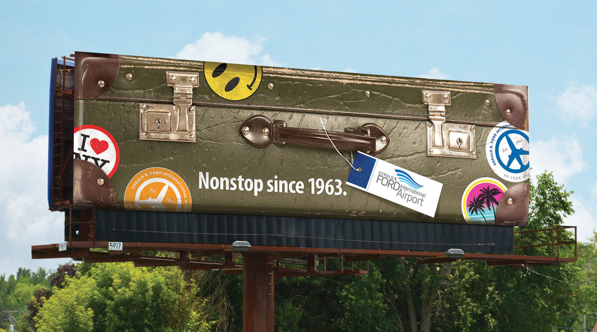 Nonstop since 1963. Out of home design with oversized suitcase.