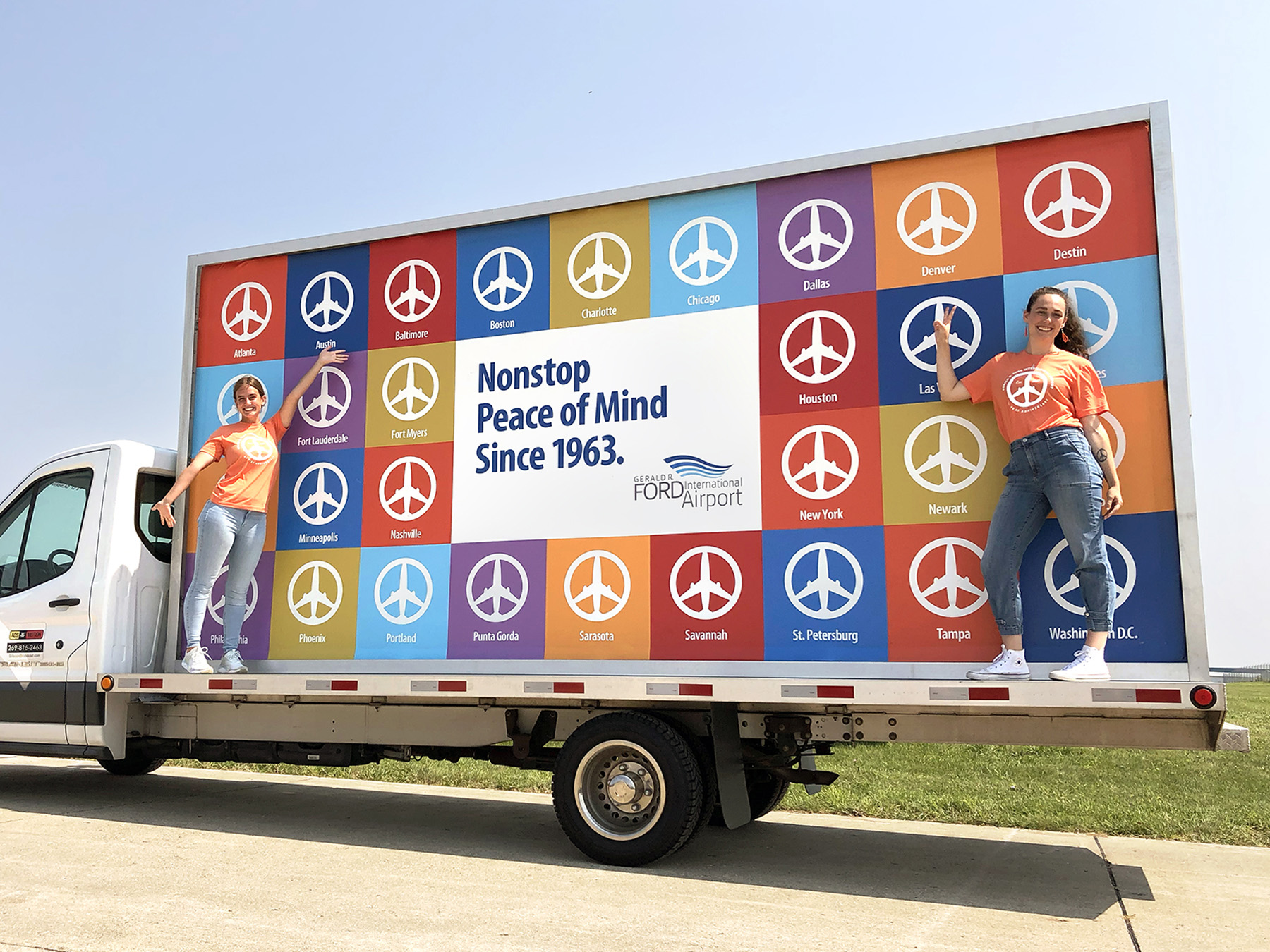 Mobile billboard advertisement for Gerald R. Ford International Airport, promoting 30 nonstop destinations in a colorful grid design. 