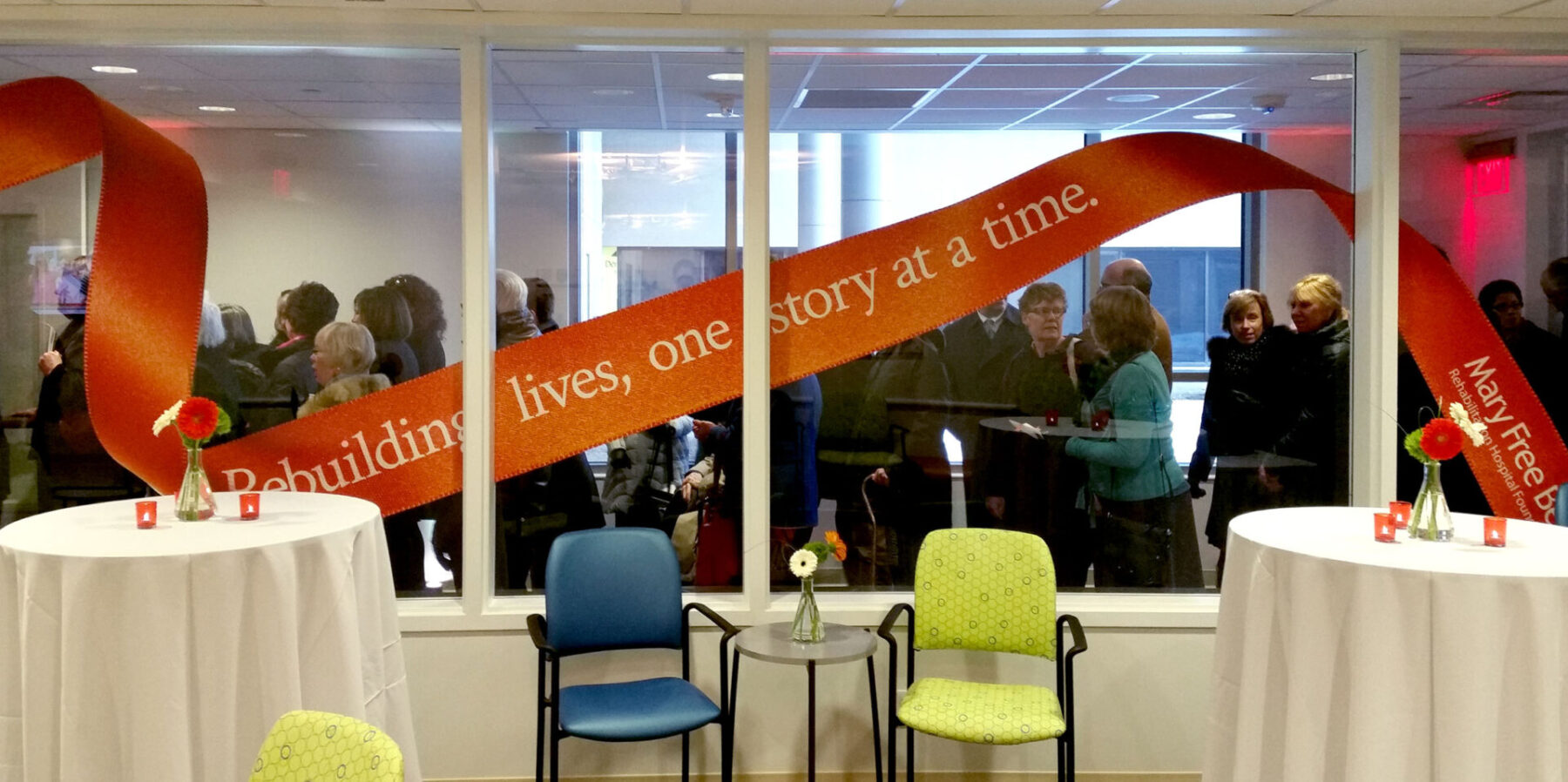 Window graphic for Mary Free Bed Rehabilitation that looks like a long winding ribbon with “Rebuilding lives, one story at a time.”