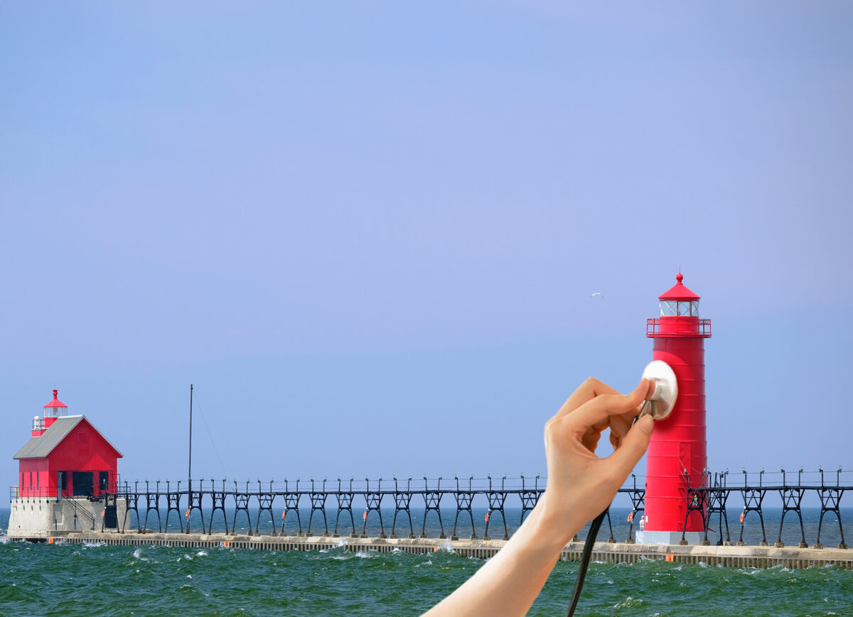 Mock image of doctor's hand using a stethoscope on a red lighthouse