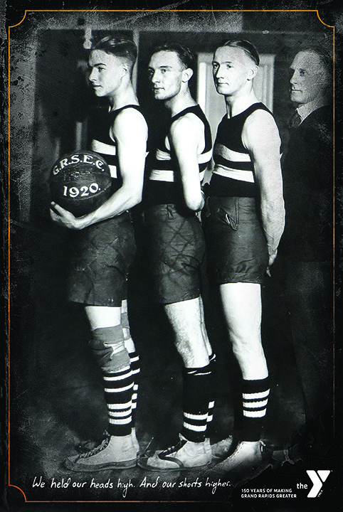 Poster with black and white historic photograph of several male basketball players and headline "We held our heads high. And our shorts higher."