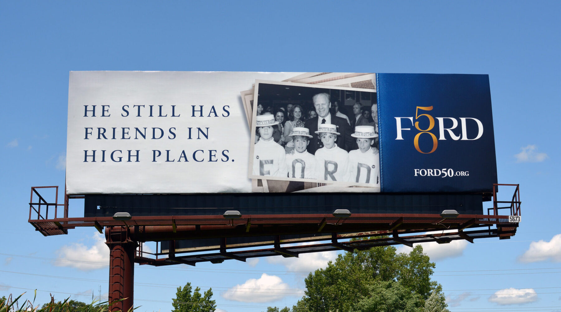 Billboard featuring a black and white image of Gerald R. Ford with some children and “He still has friends in high places.”