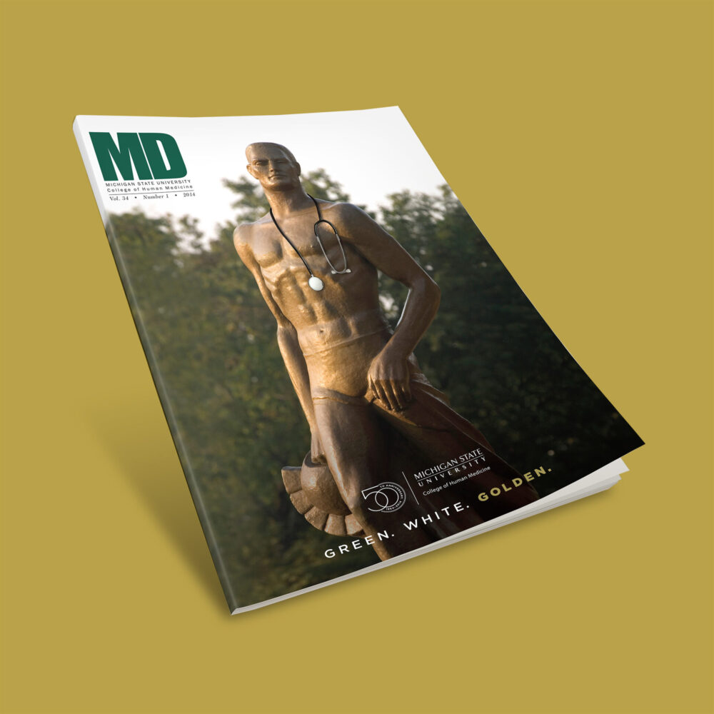 MD Magazine cover for Michigan State University College of Human Medicine featuring their spartan statue, a stethoscope, & the 50th anniversary logo.