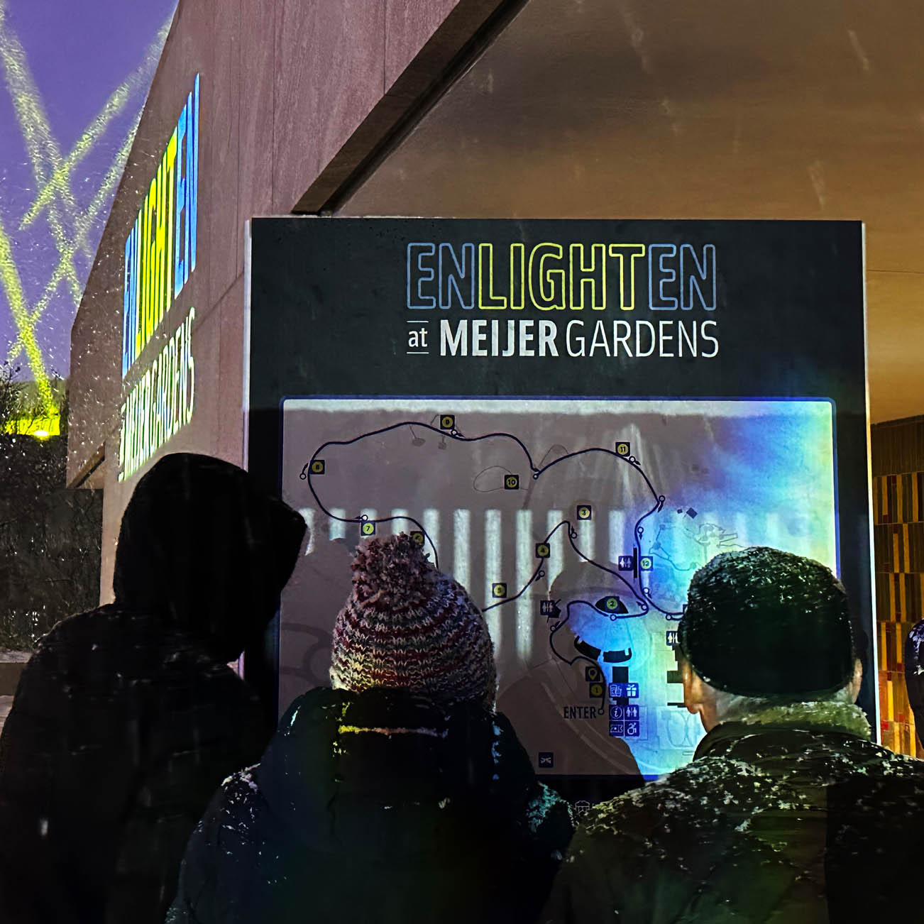 Signage installation for ENLIGHTEN exhibition, featuring a map with the logo at the top.