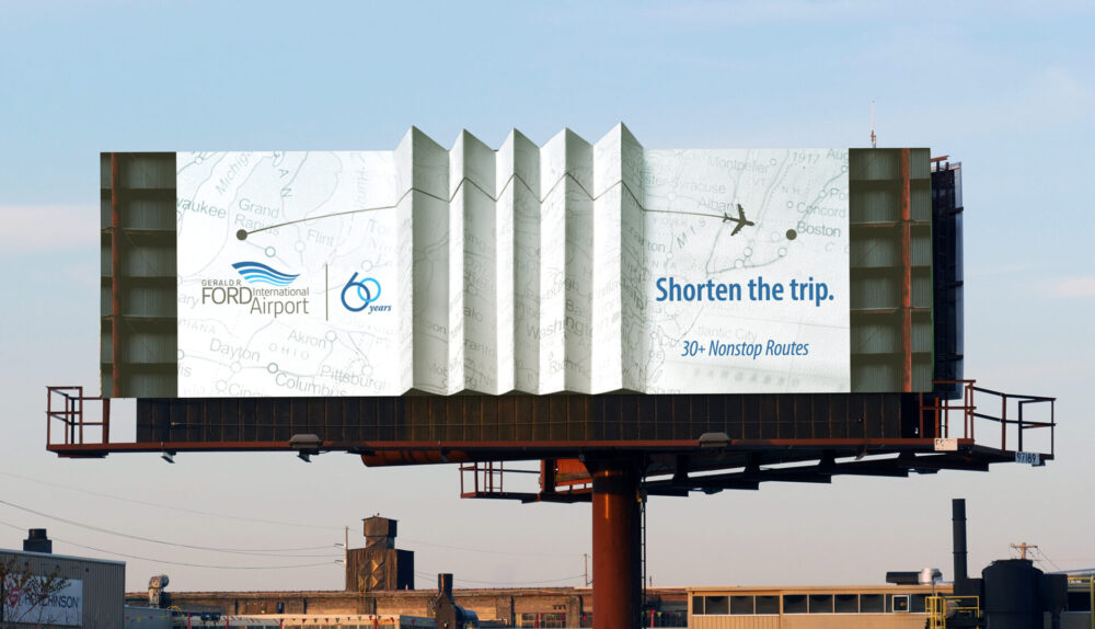 Billboard for Gerald R. Ford International Airport that makes the face appear accordion folded, creating the illusion that the two sides are closer together, with the headline “Shorten the Trip."