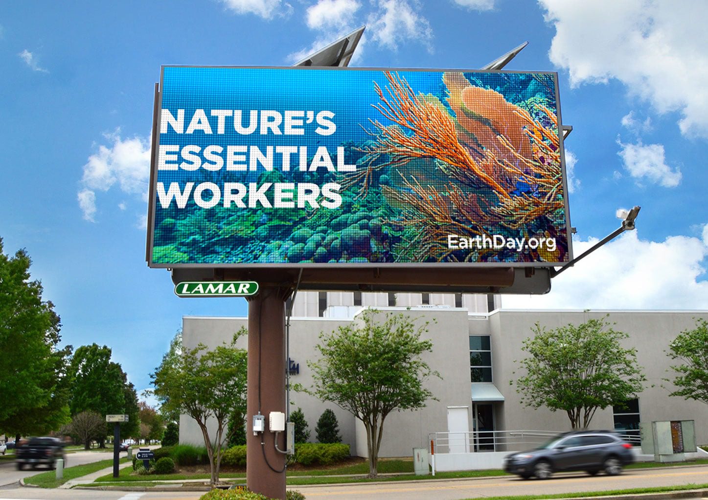 Out of home digital poster for Earthday.org showing coral and headline "nature's essential workers"