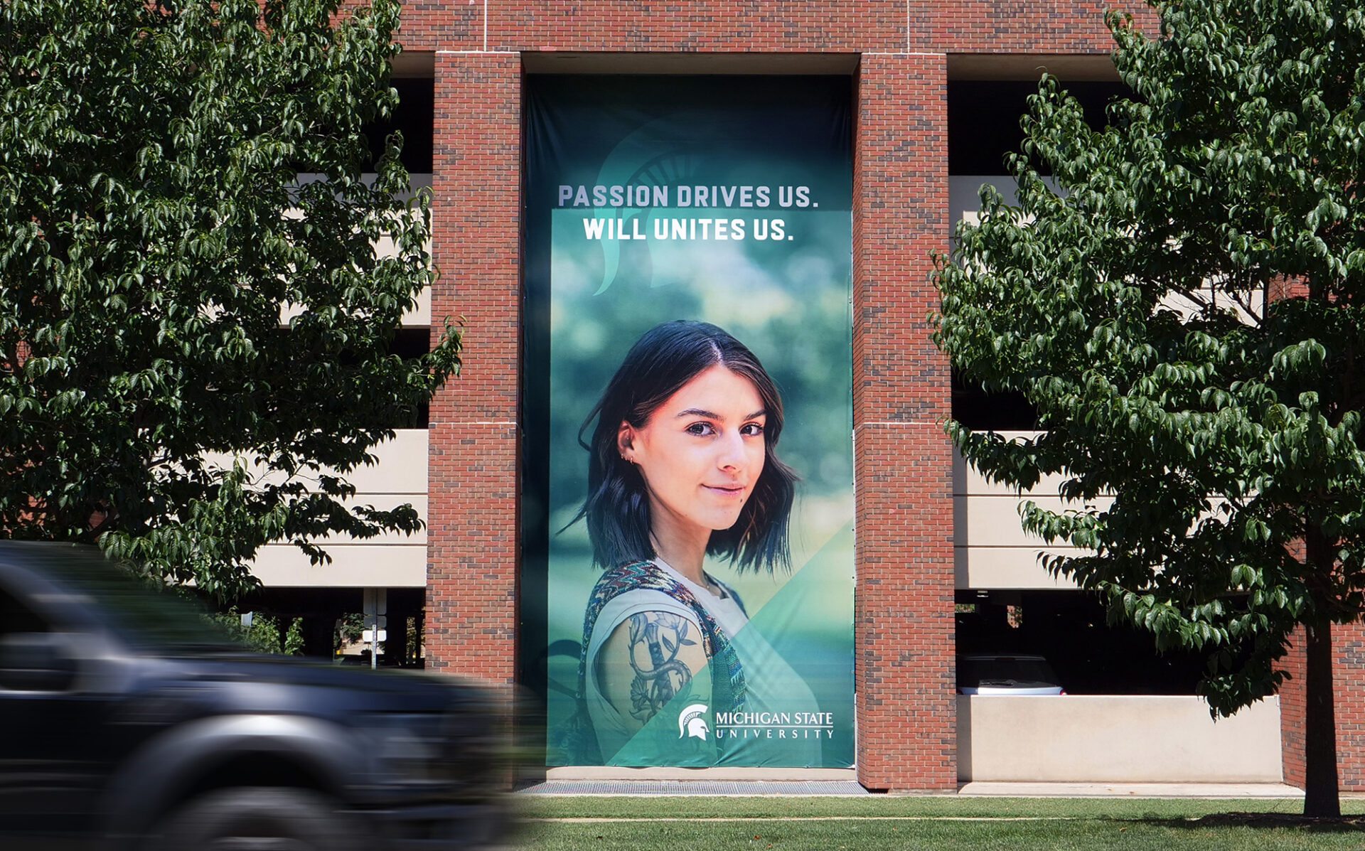 Michigan State University Exterior Banner with headline "Passion Drives Us. Will Unites Us."